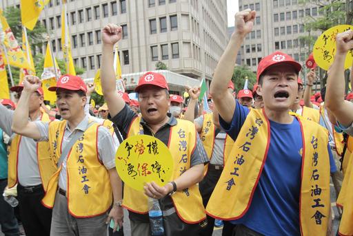 Taiwanese workers shout slogans "Strive for Working Right, Want Indemnifier" during a May Day rally in Taipei, Taiwan, Sunday, May 1, 2016. Thousands of protesters from different labor groups protest on the street to ask for raising minimum wage and shorter working hours. (AP Photo/Chiang Ying-ying)